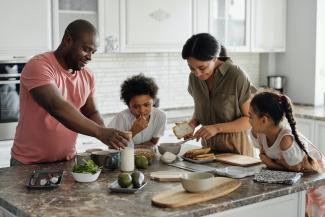 Family with two children making breakfast